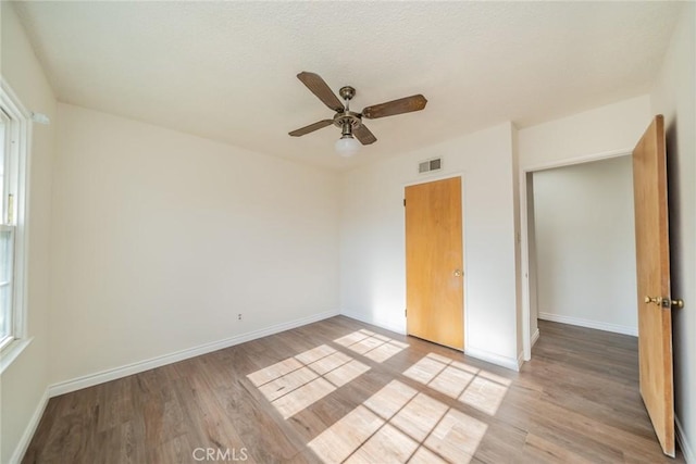 unfurnished bedroom with baseboards, visible vents, and light wood-style flooring