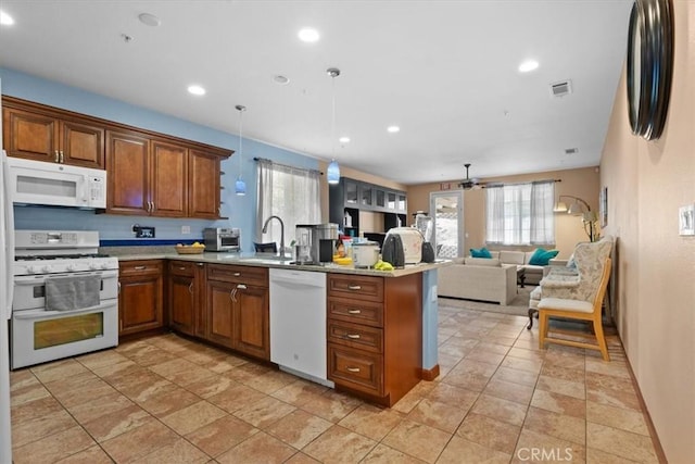 4617 Hidden Glen Dr, Antioch, CA 94531 - kitchen with brown cabinetry, visible vents, a sink, a peninsula, and white appliances