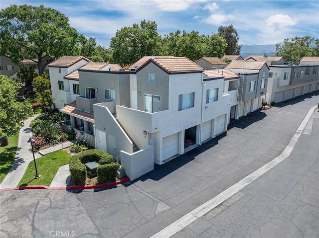 view of building exterior with aphalt driveway and a residential view