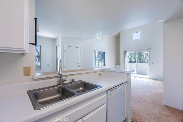 kitchen with white dishwasher, light carpet, a sink, light countertops, and white cabinetry