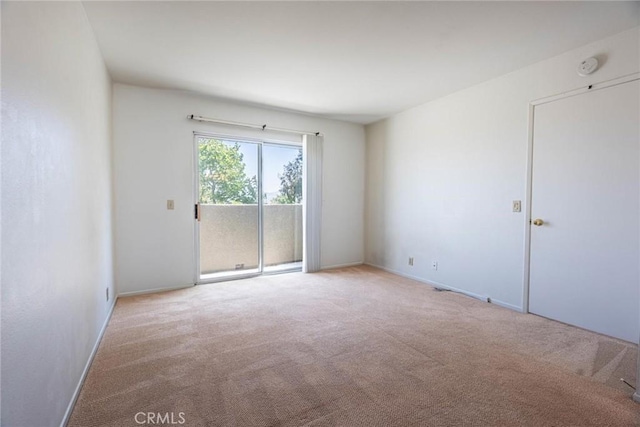carpeted empty room with baseboards