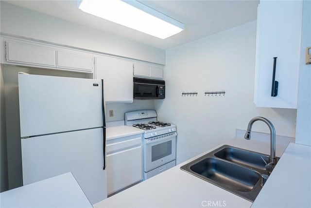 kitchen featuring a sink, white cabinetry, white appliances, and light countertops