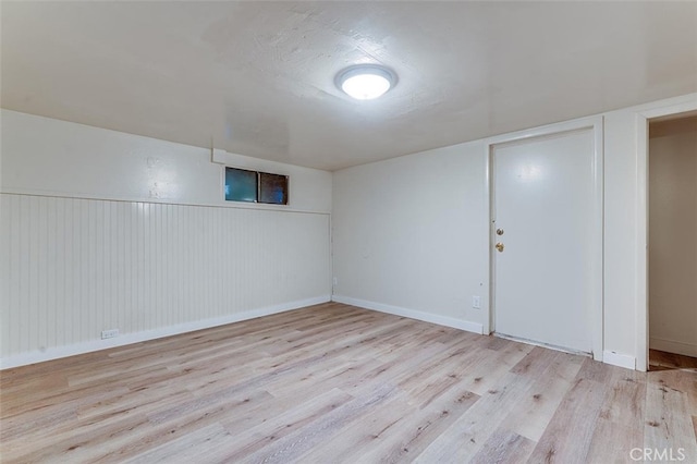 finished basement featuring baseboards and wood finished floors