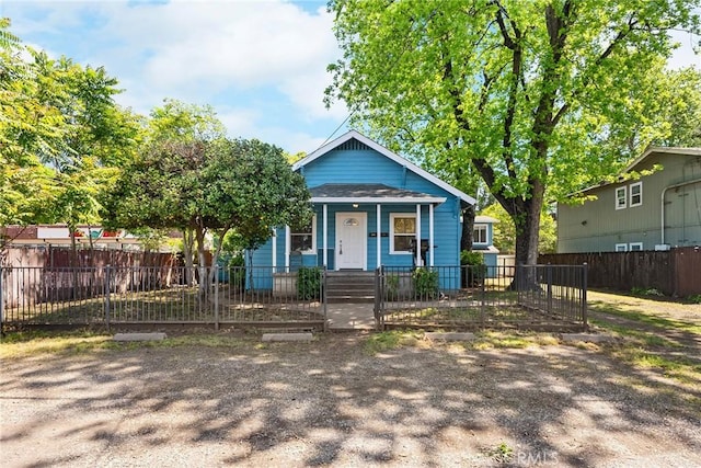 bungalow-style house featuring a fenced front yard and a porch