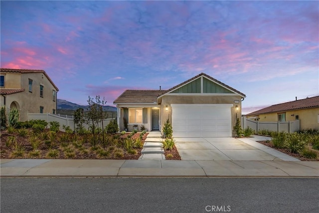 single story home featuring an attached garage, stucco siding, fence, and driveway