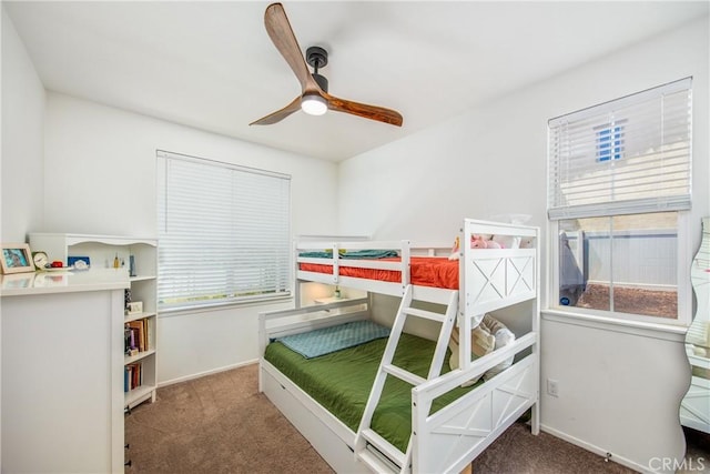 carpeted bedroom with baseboards and ceiling fan
