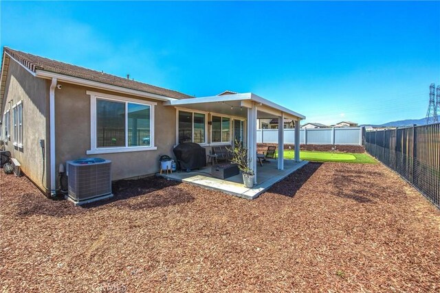 rear view of house featuring a fenced backyard, a patio, stucco siding, and cooling unit