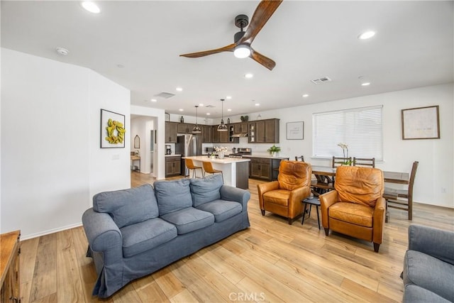 living room with recessed lighting, ceiling fan, visible vents, and light wood-type flooring