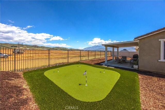 view of yard featuring a fenced backyard, a patio area, and a mountain view