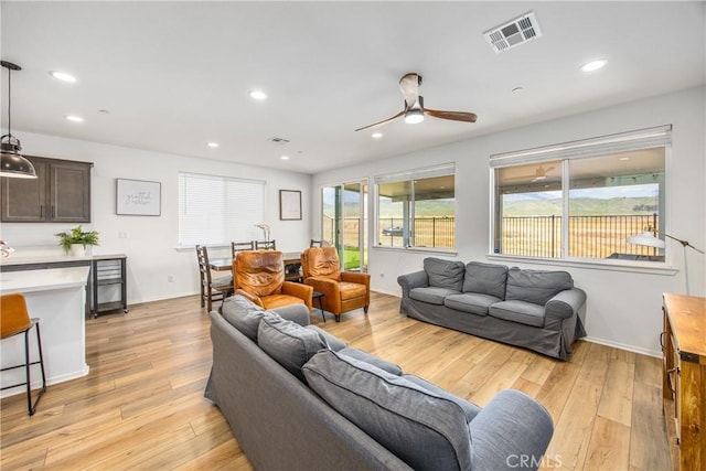 living room with recessed lighting, ceiling fan, visible vents, and light wood finished floors