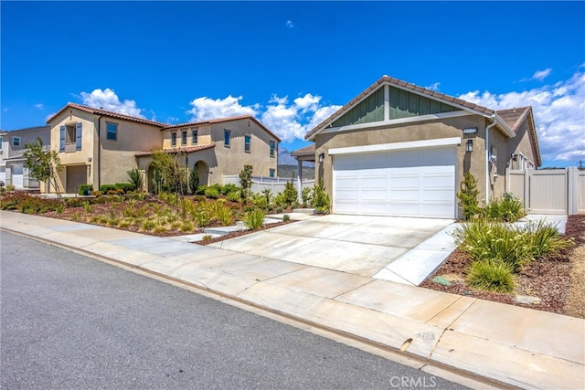 view of front of property featuring an attached garage, stucco siding, a tiled roof, and fence