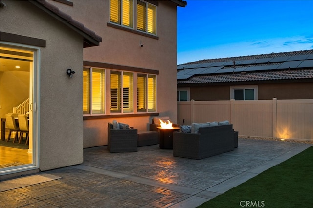 view of patio featuring fence and an outdoor living space with a fire pit