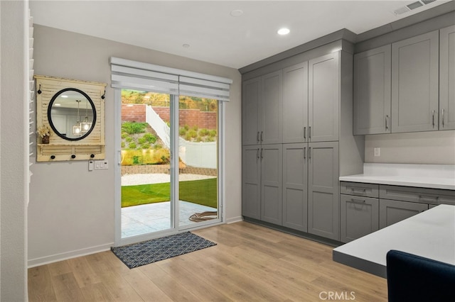 entryway with recessed lighting, baseboards, light wood finished floors, and visible vents