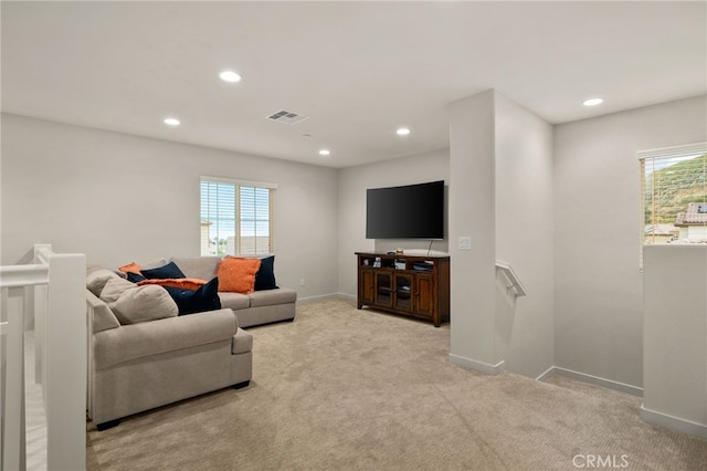 living room featuring carpet floors, baseboards, recessed lighting, and visible vents