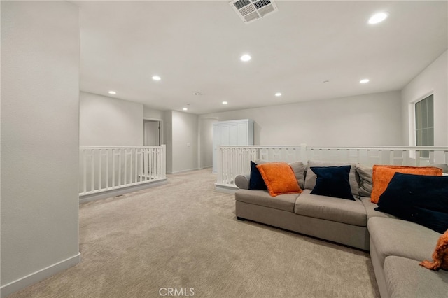 carpeted living area featuring visible vents, recessed lighting, and baseboards
