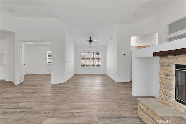 40684 Corte Albara, Murrieta, CA 92562 - unfurnished living room with ceiling fan, light wood-style flooring, and a stone fireplace