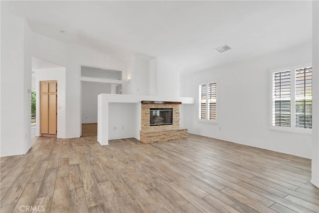 40684 Corte Albara, Murrieta, CA 92562 - unfurnished living room with visible vents, a fireplace, and light wood-type flooring
