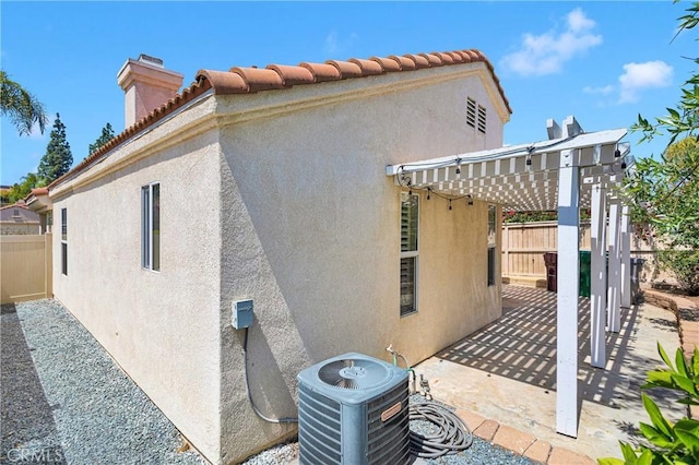 40684 Corte Albara, Murrieta, CA 92562 - back of property featuring stucco siding, central AC unit, fence, and a chimney