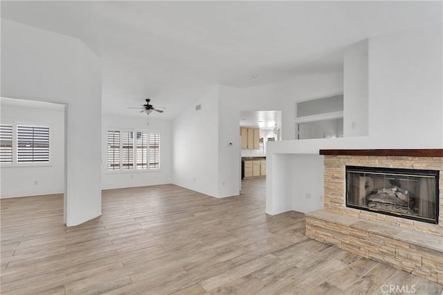 40684 Corte Albara, Murrieta, CA 92562 - unfurnished living room featuring a fireplace, ceiling fan, lofted ceiling, and light wood-type flooring