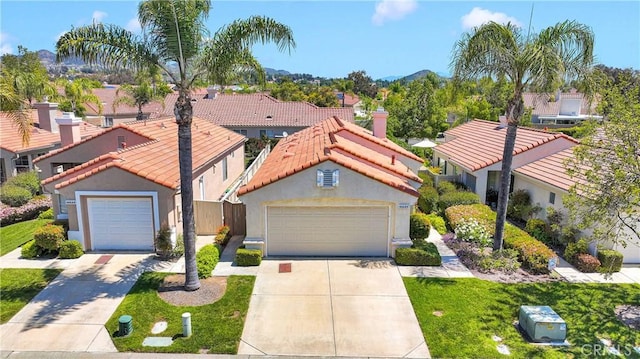 40684 Corte Albara, Murrieta, CA 92562 - mediterranean / spanish-style house featuring driveway, a tile roof, a residential view, a garage, and stucco siding