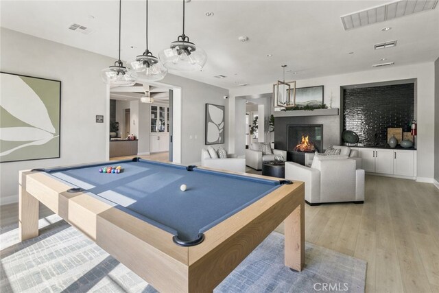 playroom with visible vents, a ceiling fan, and light wood finished floors