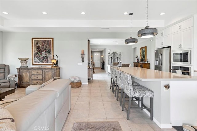 32148 Sedge Way, Temecula, CA 92591 - kitchen with stainless steel appliances, open floor plan, recessed lighting, white cabinets, and light tile patterned floors