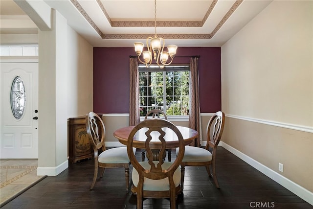 14124 Rollins Ct, Magalia, CA 95954 - dining room featuring an inviting chandelier, baseboards, a tray ceiling, and dark wood finished floors