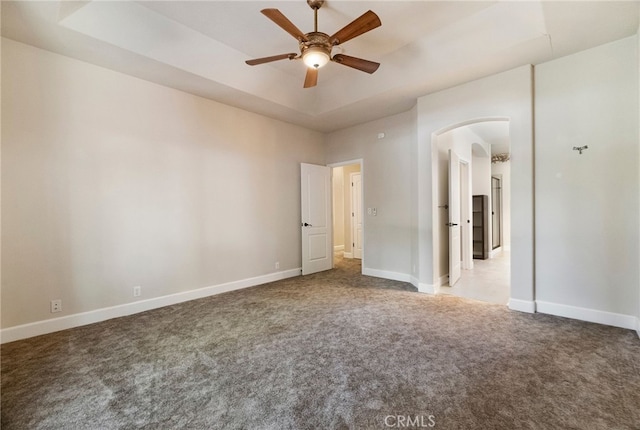 14124 Rollins Ct, Magalia, CA 95954 - unfurnished bedroom featuring baseboards, arched walkways, ceiling fan, and carpet flooring