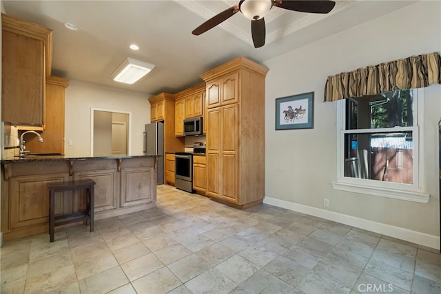 14124 Rollins Ct, Magalia, CA 95954 - kitchen with ceiling fan, appliances with stainless steel finishes, a sink, baseboards, and dark stone counters