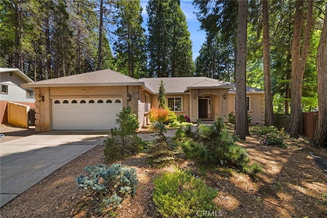 14124 Rollins Ct, Magalia, CA 95954 - ranch-style house with stucco siding, fence, driveway, and a garage