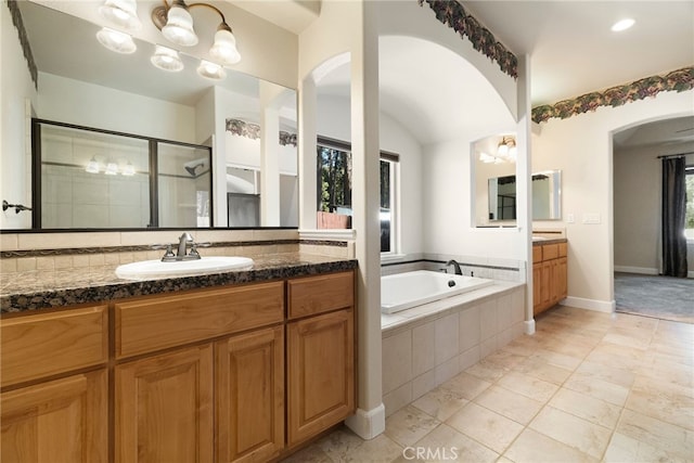14124 Rollins Ct, Magalia, CA 95954 - full bathroom featuring baseboards, a bath, two vanities, a shower stall, and a sink