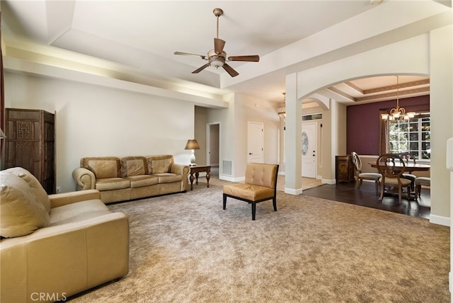 14124 Rollins Ct, Magalia, CA 95954 - living area featuring carpet flooring, arched walkways, ceiling fan with notable chandelier, baseboards, and a tray ceiling