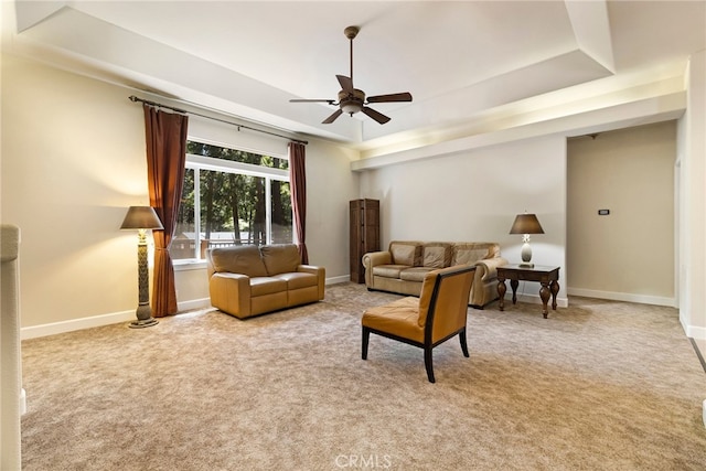 14124 Rollins Ct, Magalia, CA 95954 - living area with baseboards, ceiling fan, a tray ceiling, and carpet flooring