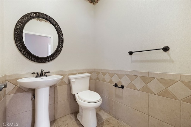 14124 Rollins Ct, Magalia, CA 95954 - bathroom featuring a sink, tile walls, wainscoting, and toilet