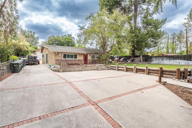 31869 Florida St, Redlands, CA 93373 - exterior space featuring concrete driveway, stucco siding, fence, and a front lawn