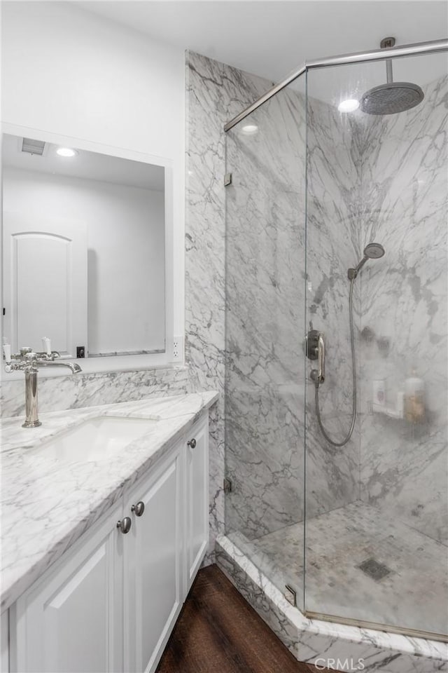 31869 Florida St, Redlands, CA 93373 - full bath featuring a marble finish shower, wood finished floors, vanity, and visible vents
