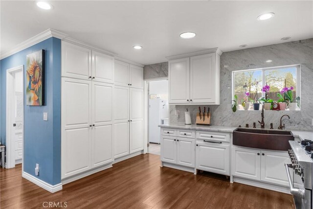 31869 Florida St, Redlands, CA 93373 - kitchen featuring a sink, high end stove, white cabinetry, and dark wood finished floors