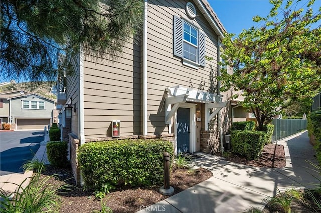 13836 Balboa Blvd Unit 164, Sylmar, CA 91342 - view of front facade featuring fence and a garage