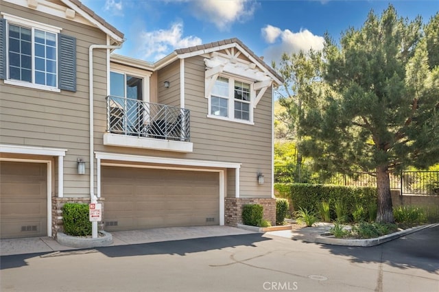 13836 Balboa Blvd Unit 164, Sylmar, CA 91342 - view of property with an attached garage, a balcony, and driveway