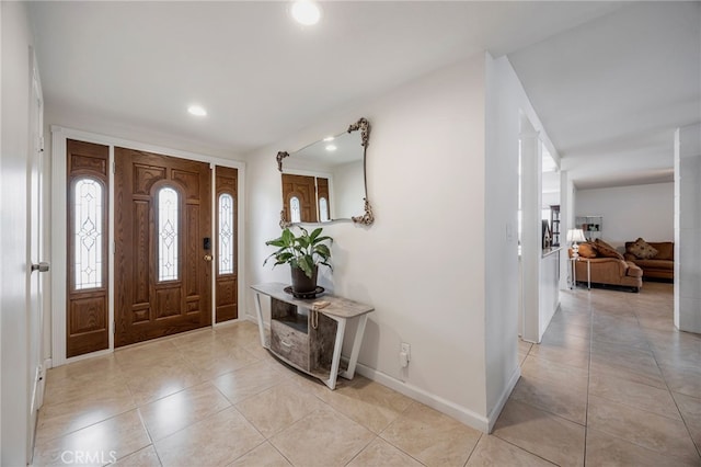 foyer featuring baseboards, recessed lighting, and light tile patterned floors