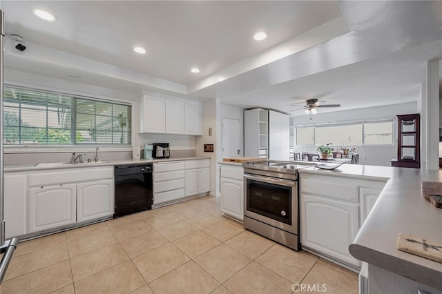 kitchen featuring plenty of natural light, a sink, stainless steel range with electric stovetop, and black dishwasher
