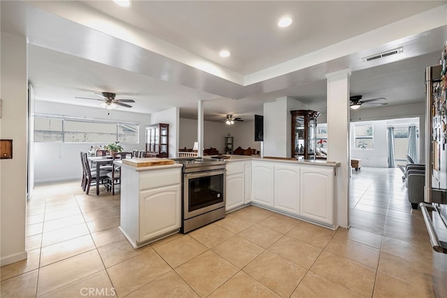 kitchen with visible vents, open floor plan, ceiling fan, and stainless steel electric stove