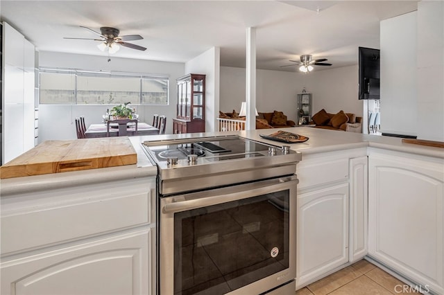 kitchen featuring stainless steel electric stove, light countertops, and ceiling fan