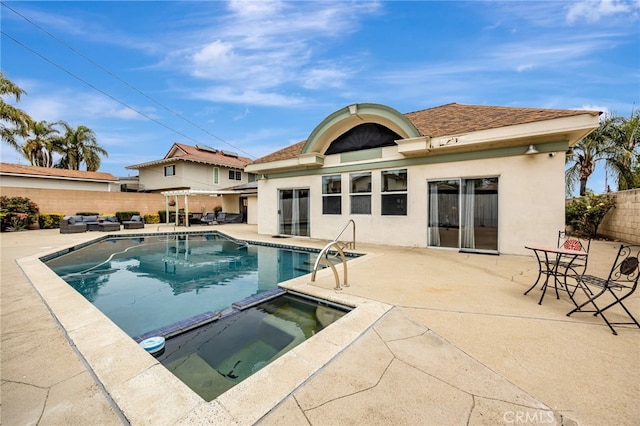 view of pool with a patio, a pool with connected hot tub, and a fenced backyard