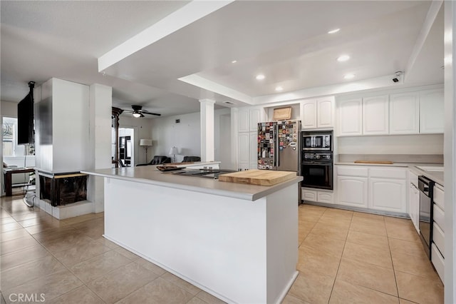 kitchen featuring ceiling fan, open floor plan, decorative columns, light tile patterned floors, and black appliances
