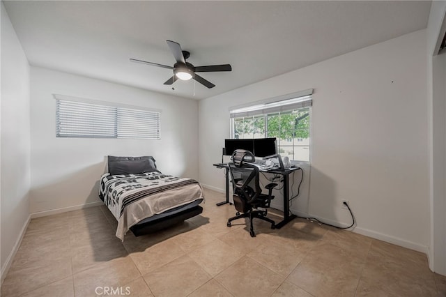 bedroom featuring light tile patterned floors, baseboards, and ceiling fan
