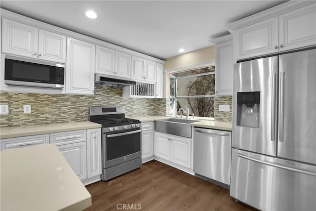 kitchen featuring a sink, white cabinets, stainless steel appliances, and under cabinet range hood