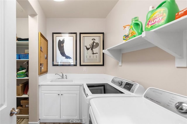 washroom with washer and clothes dryer, a sink, and cabinet space
