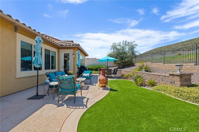 view of yard with outdoor lounge area, a fenced backyard, and a patio area