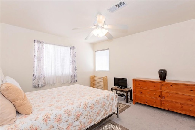 bedroom with carpet floors, ceiling fan, and visible vents